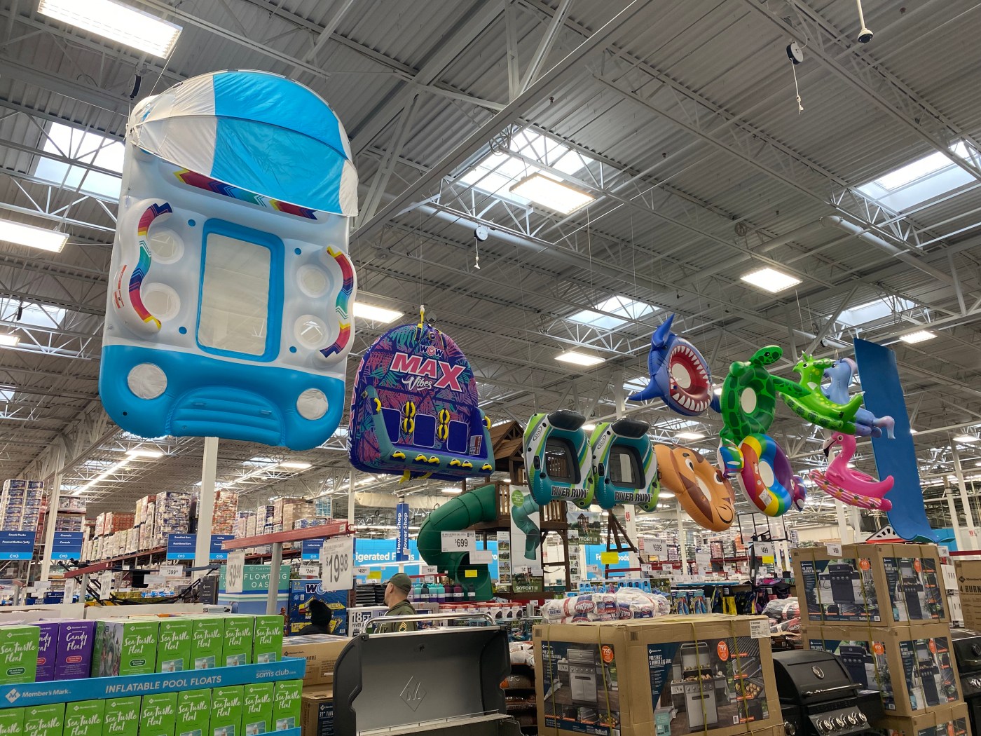 Inflated floatation devices hanging from the ceiling in a big box store